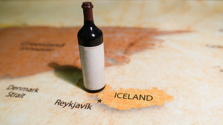 A bottle of red wine on a map of Iceland