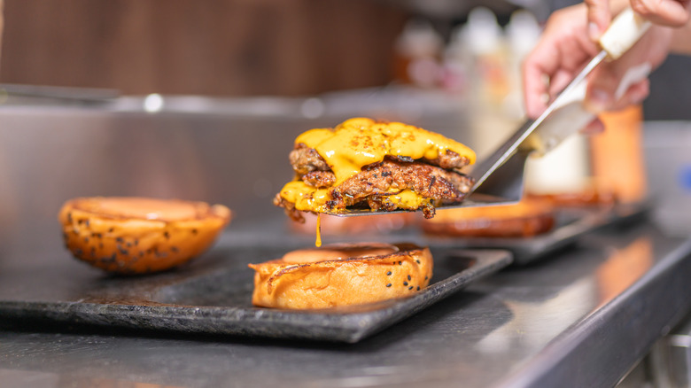 Chef assembling cheeseburger