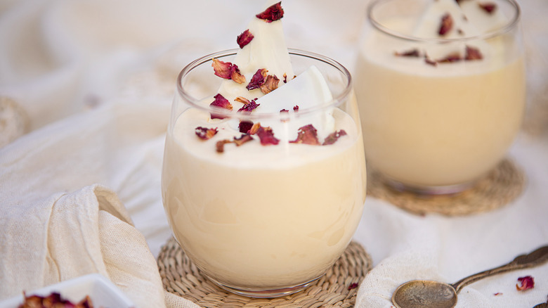 Glasses of white chocolate mousse with dried rose petals