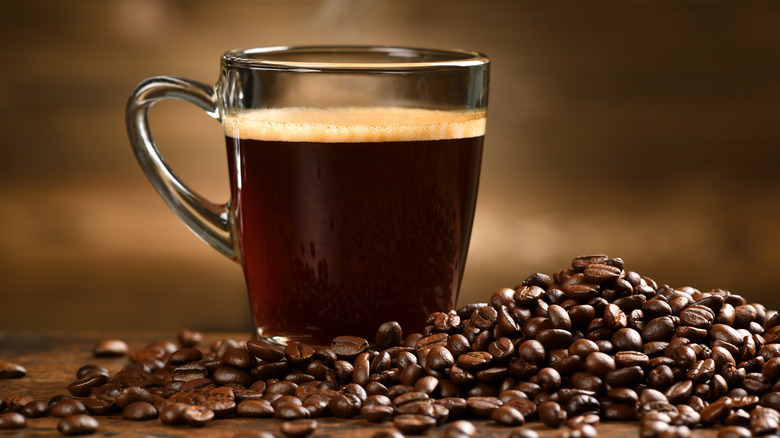 mug of coffee near coffee beans