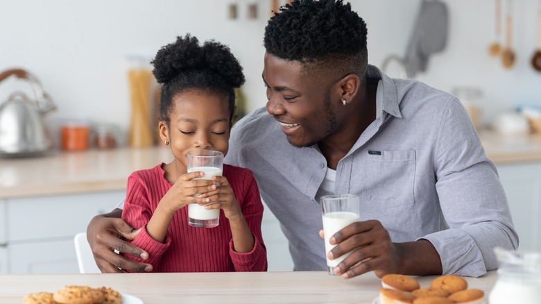 Parent and child drinking milk 