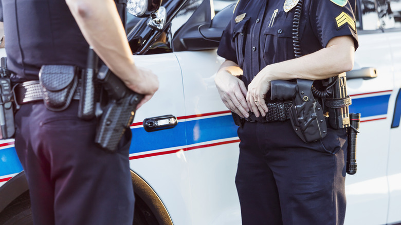 police officers in front of their vehicle