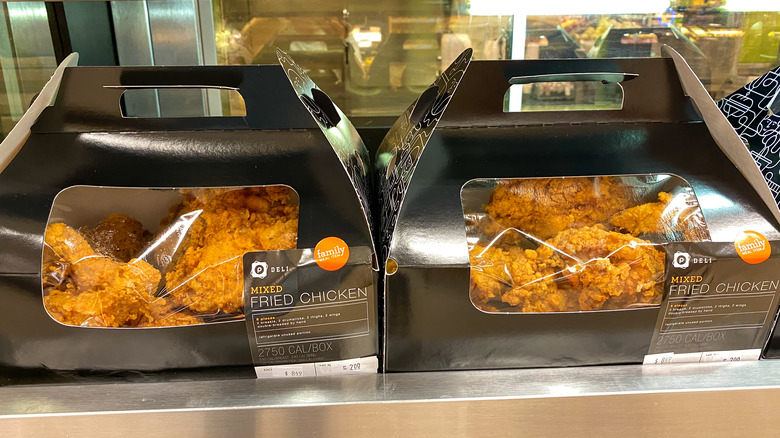 Two boxes of Publix fried chicken in a warming display in a supermarket