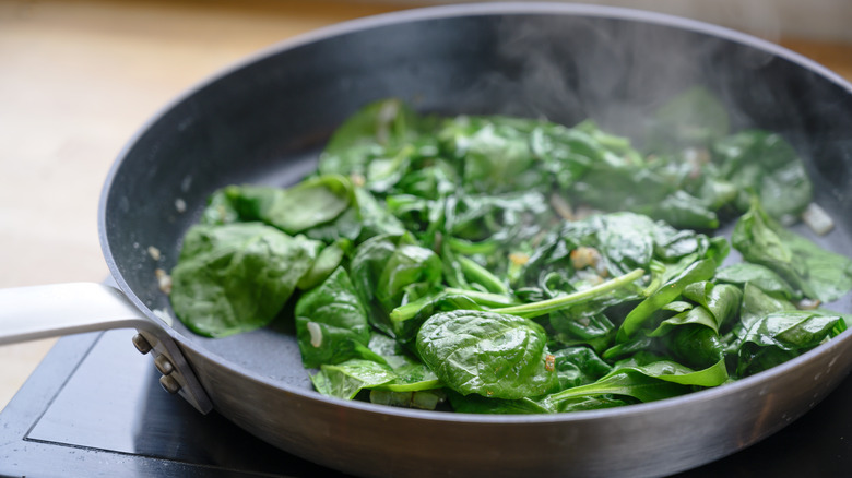 Cooking baby spinach in a saute pan
