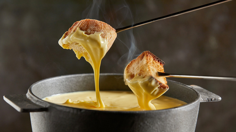 Pieces of bread dipped in fondue