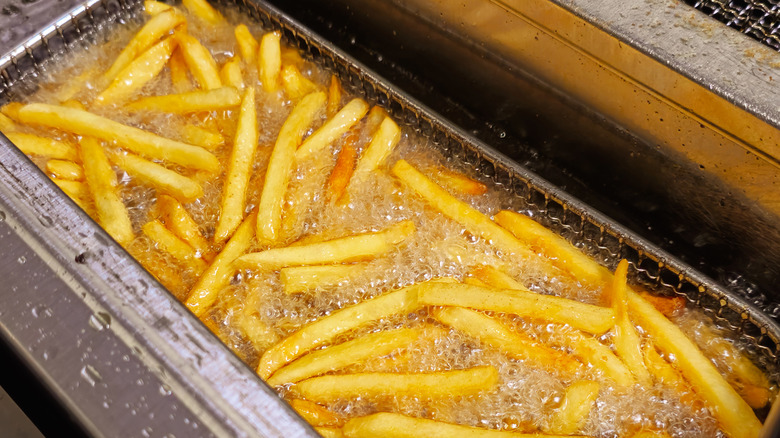 French fries cooking in a deep fryer