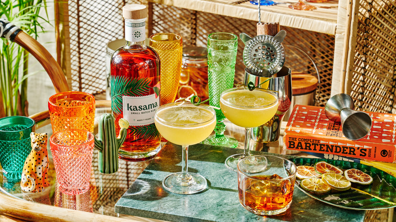 Bottle of Kasama beside cocktails