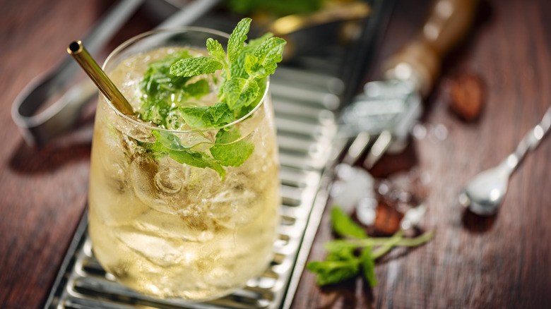 a cocktail made with ginger ale and mint on a bar