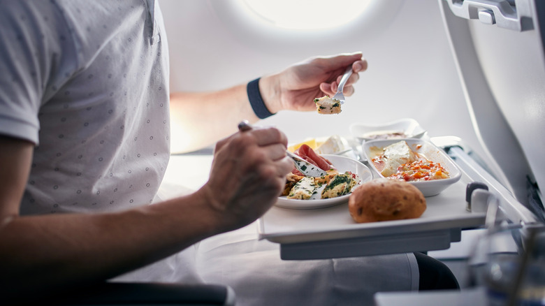 Person eating food on a flight