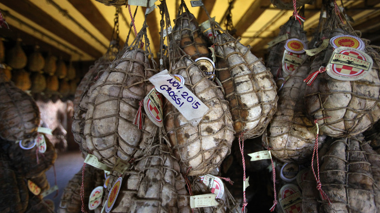 Suspended culatelli aging in cellar