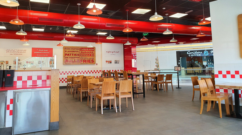 A Five Guys restaurant sits empty