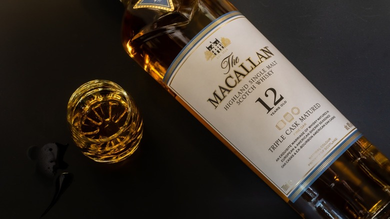 A bottle of The Macallan and a class on a dark background