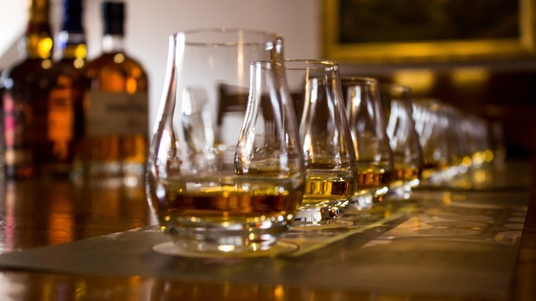 A line of tasking glasses filled with whisky