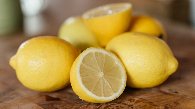 a few lemons on a wooden board