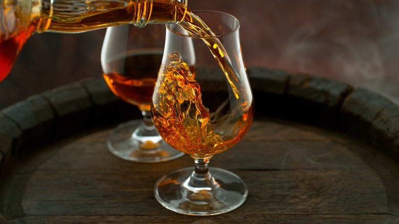 Close-up of whiskey pouring into glass