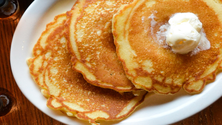 Plate of Cracker Barrel pancakes with scoop of butter