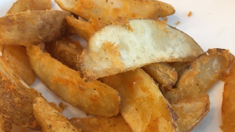 battered potato wedges on plate