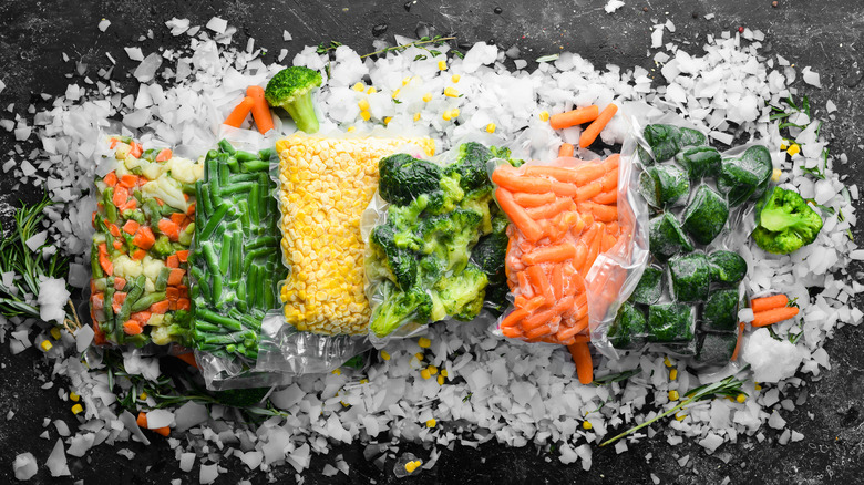 Assortment of packaged frozen vegetables over ice