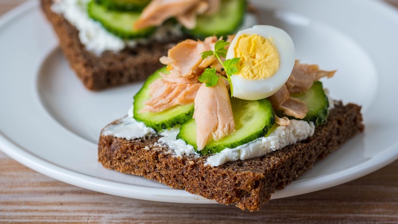 Danish smørrebrød with egg and fish on a plate