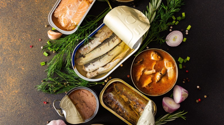 Assortment of tinned fish and fresh herbs