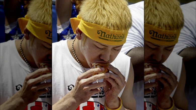 Takeru Kobayashi eating hot dog bun soaked in water