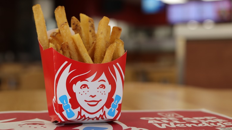 A pouch of Wendy's french fries with the Wendy's mascot logo printed on the front