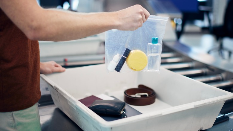 person holding liquids in bag at TSA
