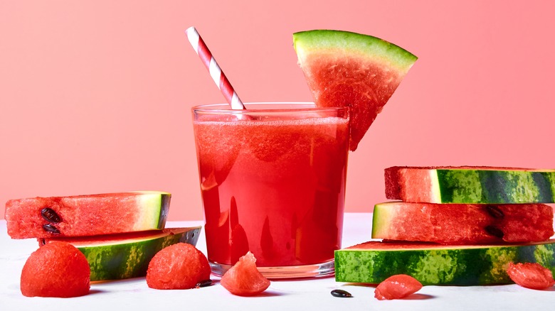 Watermelon juice in glass with watermelon wedges