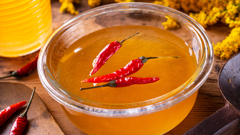 Bowl of honey with chili peppers