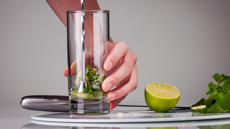 Person muddling herbs