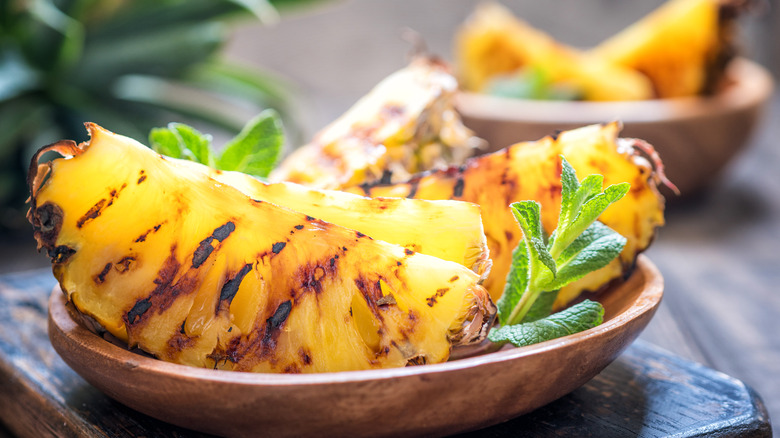 grilled slices of pineapple in a bowl