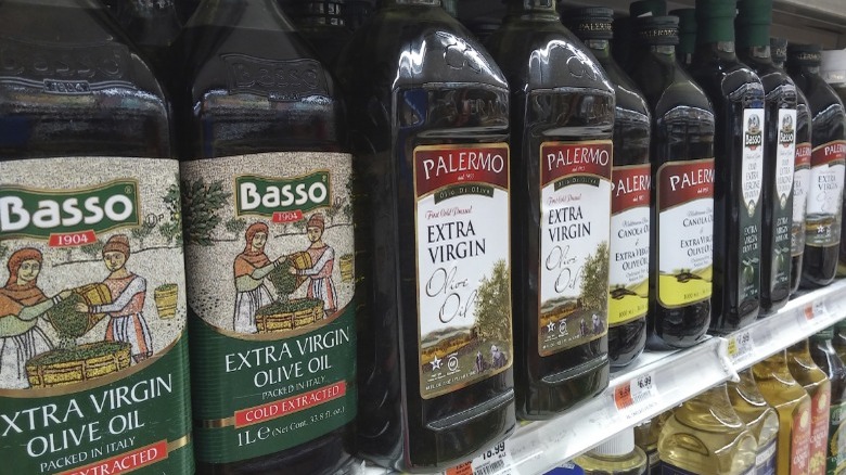 Bottles of olive oil on a grocery store shelf