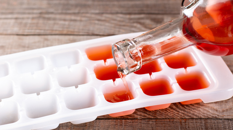 Pouring wine into ice cube tray