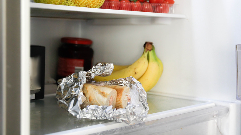 Pieces of bread sitting inside a fridge.