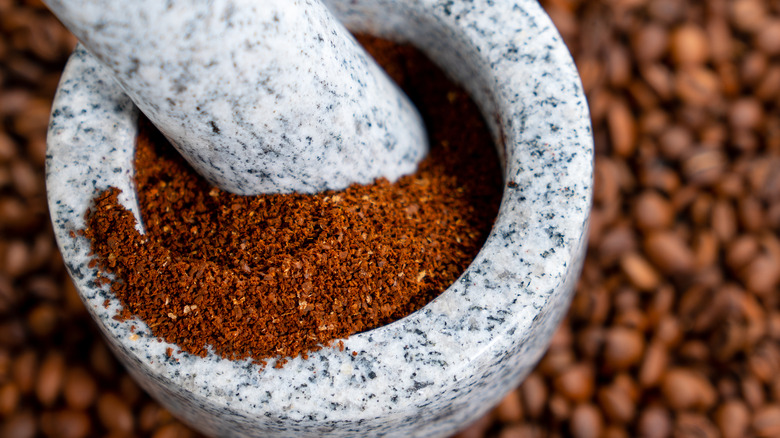 Coffee grounds in a mortar and pestle