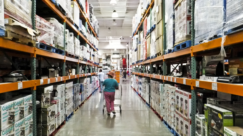 Female shopper walks down an empty aisle at Costco Wholesale