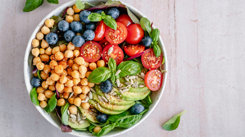 Colorful salad with garbanzos, blueberries, tomatoes, and avocado