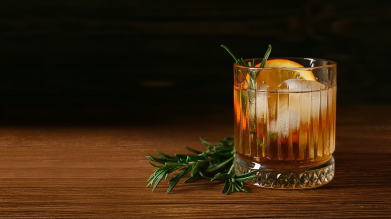 Cocktail in glass with rosemary