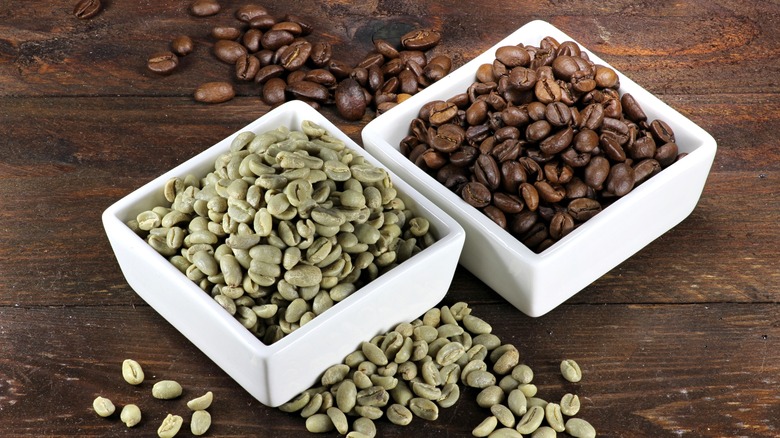 Unroasted and roasted coffee beans in dishes