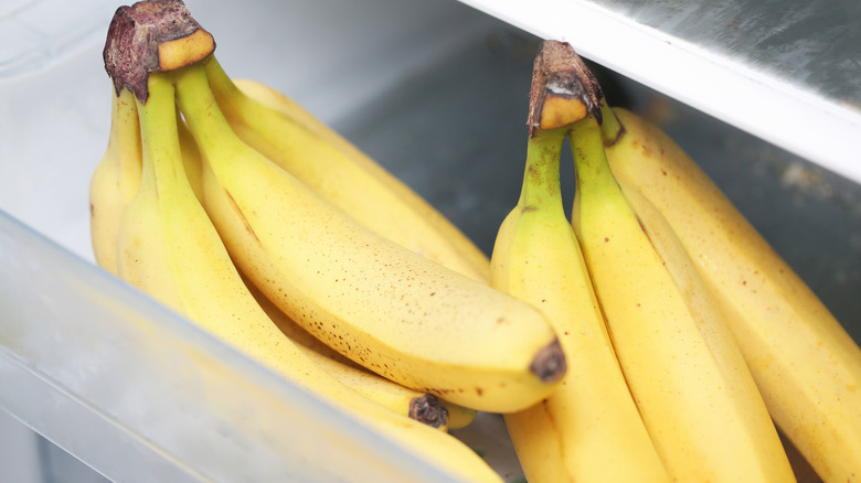 Two bunches of bananas in fridge