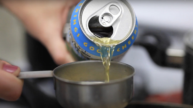 pouring beer into measuring cup