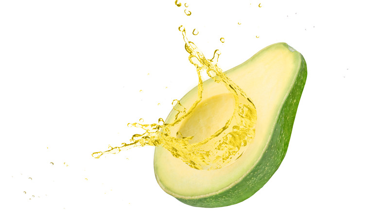 Avocado with splashing oil 