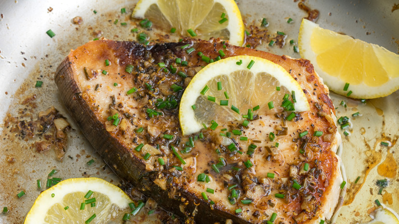 Fish being seared with lemons