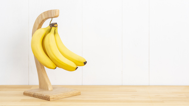 Bananas hanging on a counter