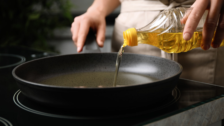 pouring vegetable oil into pan