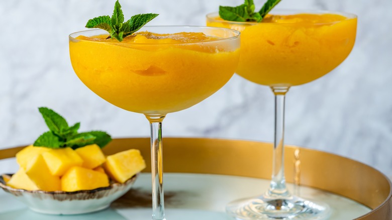 Frozen mango daiquiris in cocktail glasses 