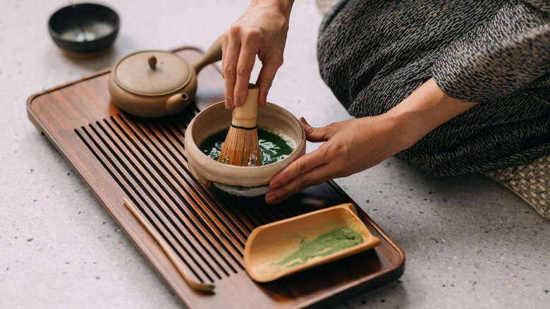 Woman making matcha with chasen