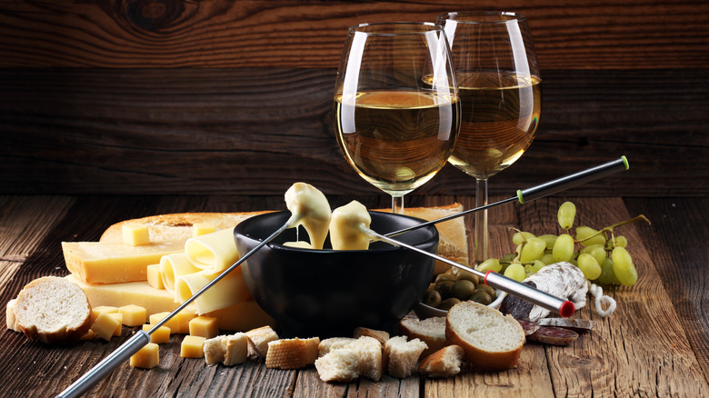 Cheese fondue with glasses of white wine