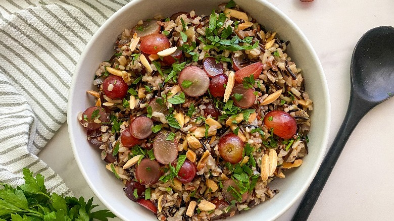 bowl of wild rice pilaf with black spoon