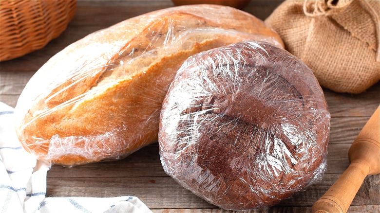 Bread loaves covered in plastic wrap